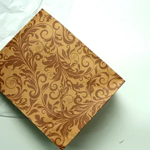Detailed close-up of vintage brown paper gift bag featuring classic floral leaf damask pattern.