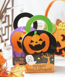 Halloween candy gift box detail showing cute pumpkin ghost design and festive paper handle setup.