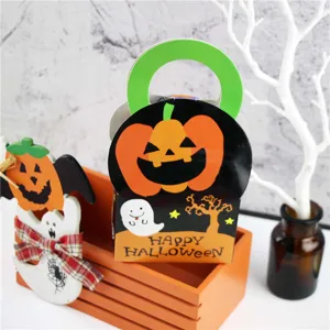Halloween candy gift box detail showing cute pumpkin and ghost print with green handle.