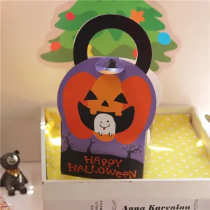 Halloween pumpkin ghost paper gift box detail showing cute handle and festive holiday design.