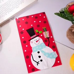 Christmas paper gift bag with cute snowman design, perfect for children holiday presents and packaging.