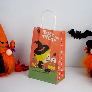 Halloween paper gift bag detail view showing witch and pumpkin print with paper handles.