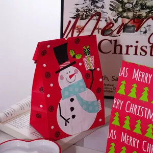 Christmas paper gift bag detail view, festive snowman and tree print design, holiday packaging decor.