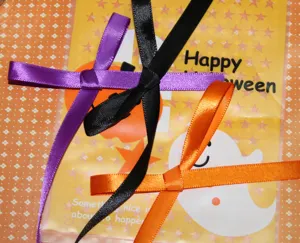Satin ribbon detail view, 1cm purple black orange craft ribbon for Halloween gift packaging.