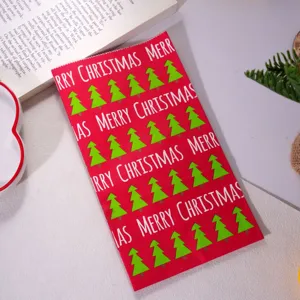 Christmas gift paper bag with cute tree prints, perfect for holiday present wrapping.