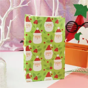 Close-up of green paper gift bag with cute Santa Claus pattern and white paper handles.