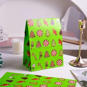 Green Christmas paper gift bag detail, festive candy and tree patterns for holiday gifts.
