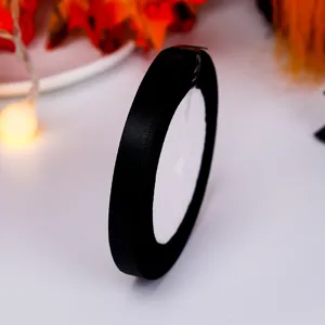 Black satin ribbon roll for gift wrapping and DIY crafts, 1cm width, perfect for packaging.