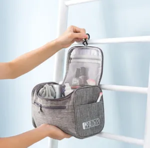Hanging travel toiletry bag with multiple mesh compartments and hook for easy portable storage.