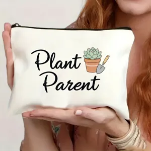 Nahaufnahme der weißen Leinen Kosmetiktasche mit Pflanzen Motiv und praktischem Reißverschluss.