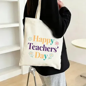 Detailed view of large capacity canvas tote bag with teacher day print and floral pattern.