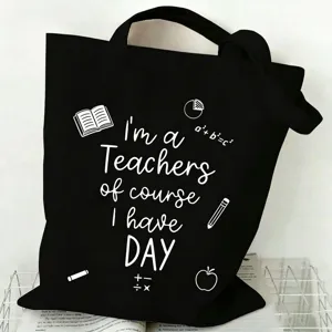 Detailed view of a black canvas tote bag featuring teacher quotes and cute educational icons.