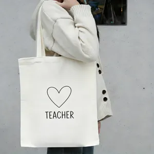 Witte canvas shopper tas met hart en leraar print, ruim en handig voor dagelijks gebruik.