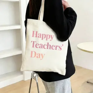 Detail shot of the canvas tote bag with pink Happy Teachers Day print, casual daily scene use.