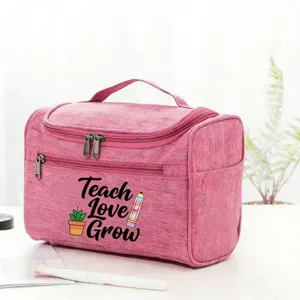 Pink travel cosmetic bag for teachers, cute design with handle and zipper pockets.