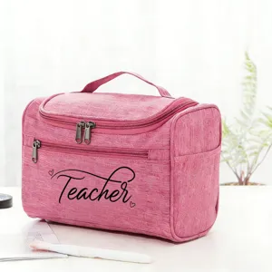 Pink teacher cosmetic bag detail view showing sturdy handle, dual zippers, and fabric texture.
