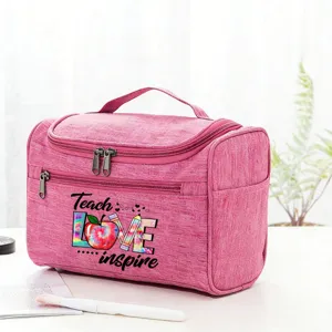 Pink travel cosmetic bag detail showing teacher theme print and durable canvas material for use.