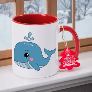 Detailopname van een wit-rood keramische koffiemok met een schattig cartoon blauwe vinvis design.