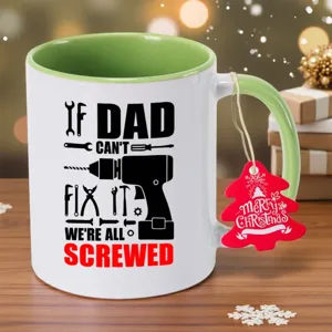 Detailed view of a white and green ceramic coffee mug featuring funny tool graphics and dad quote.