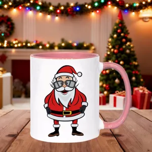 Christmas ceramic mug with pink handle and cute Santa Claus print for holiday seasonal gifts.