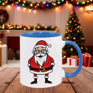 Close-up detail of festive Christmas ceramic mug with blue handle and cute Santa graphic.