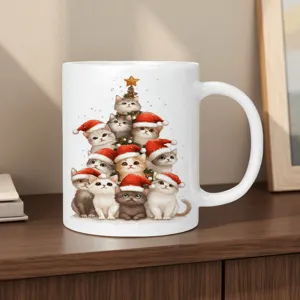 White ceramic coffee mug featuring a cute Christmas cat tree design for holiday seasons.