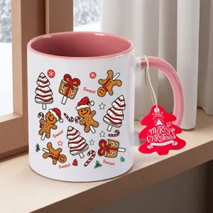Christmas ceramic coffee mug with cute gingerbread man pattern and festive pink and white design.