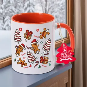 Christmas ceramic mug with orange handle and cute gingerbread man print for holiday drinks.