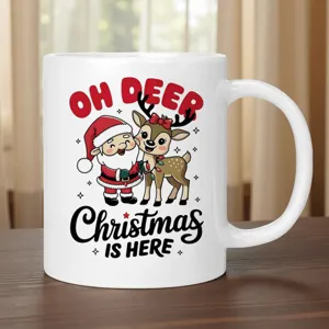 Close-up detail of white ceramic coffee mug featuring cute Santa Claus and reindeer print design.