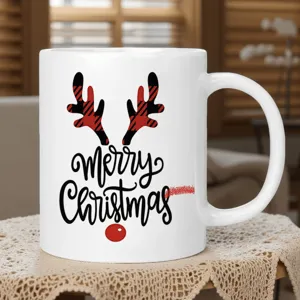 White ceramic Christmas coffee mug featuring red plaid reindeer antlers and holiday decor.