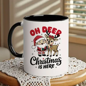 Detailed view of white ceramic coffee mug with black handle, featuring cute Christmas design.