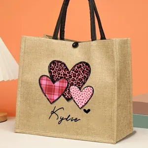 Natural jute tote bag with personalized heart print and custom name, perfect for daily use.