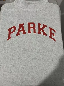 Gray mock neck sweatshirt featuring red arched PARKE letter print, soft fleece pullover detail.