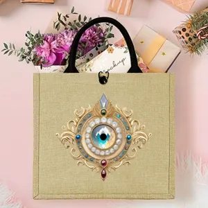 Mysterious evil eye burlap tote bag with gold vintage print, durable jute shopping bag.