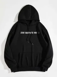 Close-up view of the black fleece hoodie featuring chest letter print and kangaroo pocket.