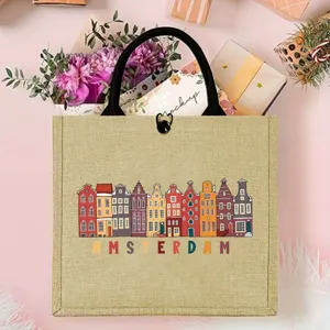 Detailed shot of burlap tote bag with colorful Amsterdam canal houses print and black handles.