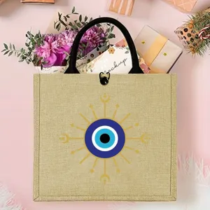 Burlap tote bag with evil eye design, durable reusable shopping bag for picnic and daily travel.