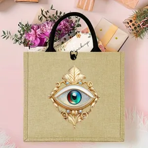 Detailed view of mystical evil eye print linen tote bag with gold baroque frame design.
