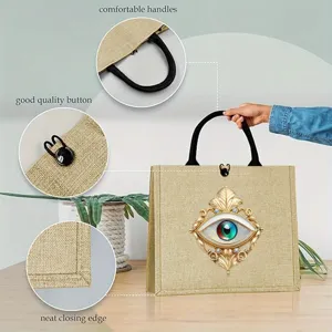 Evil eye print linen tote bag detail showing comfortable handles, button closure and neat edge.
