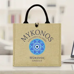 Detail view of the aesthetic jute tote bag featuring Mykonos evil eye print and black handles.