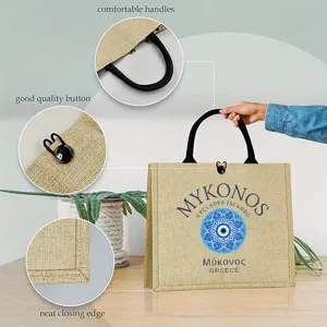 Stylish jute tote bag with evil eye print, featuring comfortable handles and button closure.