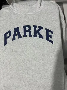 Light grey mock neck sweatshirt with bold dark blue collegiate letter print on chest detail