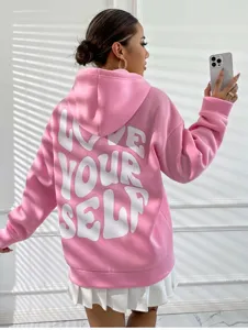 Vue détaillée du sweat à capuche rose en polaire avec impression de lettres blanches.