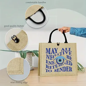 Mystical evil eye printed jute tote bag with black handles and button closure for daily use.