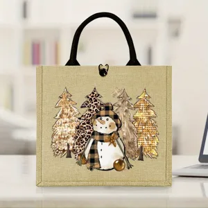 Bolsa de yute con muneco de nieve navideno y asas negras para regalos de fiestas de invierno.