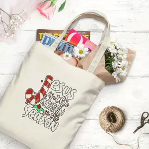 Charming Christmas canvas tote bag with festive Jesus quote print, ideal holiday gift bag.