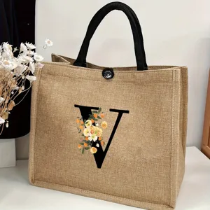 Detailed view of the large capacity jute tote bag featuring elegant floral letter V design.