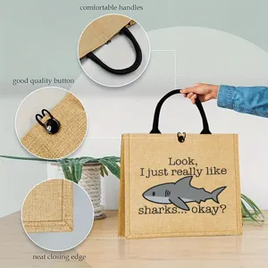 Jute tote bag featuring a cute shark print, comfortable handles, and button closure detail.