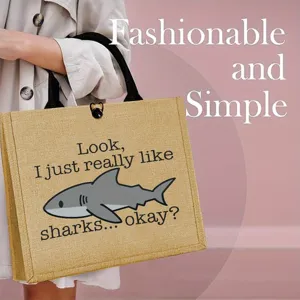 Jute tote bag with cute shark graphic print, ideal for outdoor shopping, picnics and travel.