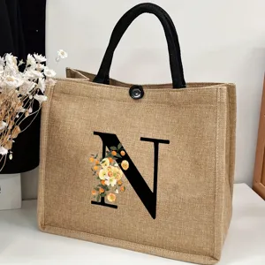 Large capacity jute tote bag with black letter N print and floral design for casual daily use.
